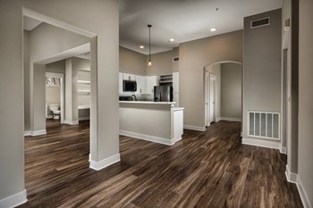 Living area with view of kitchen at The Madison at Town Center Apartments in Santa Clarita CA